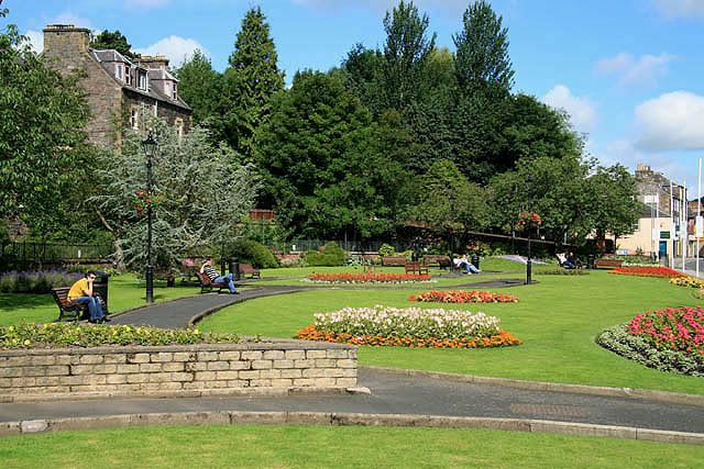 Bank Street Gardens in central Galashiels, with lawns, flower beds and surrounding buildings